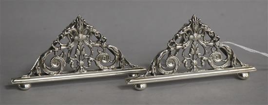 A pair of late Victorian pierced silver menu holders, William Hutton & Sons, London, 1896, width 95mm.